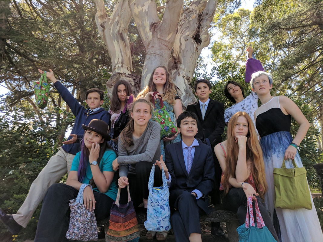 GATE graduates gathered under a eucalyptus tree on graduation day