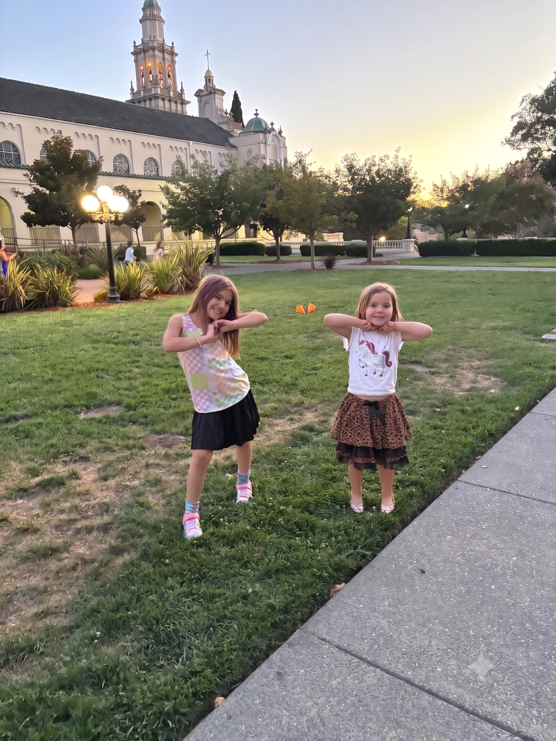 Two GATE students playing on the lawn at golden hour