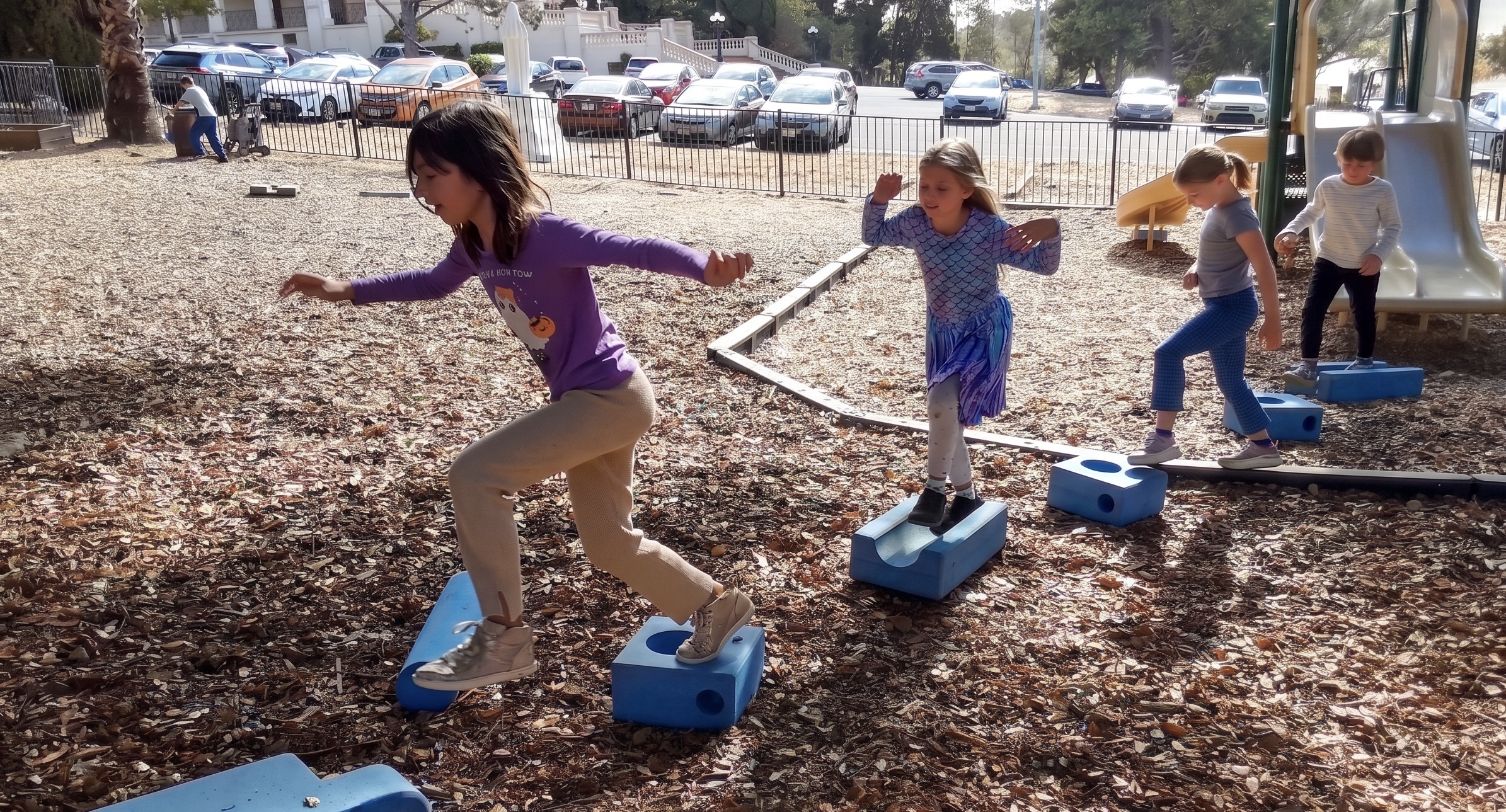 GATE students crossing the balance blocks together at recess